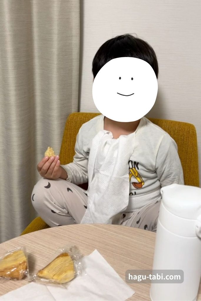 コンフォートスイーツ東京ベイの客室で持参した食べ物を食べる子ども