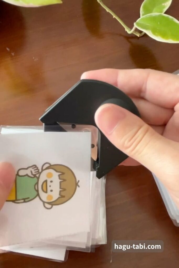 ラミネートした絵カードの四隅をコーナーカッターで丸くする様子